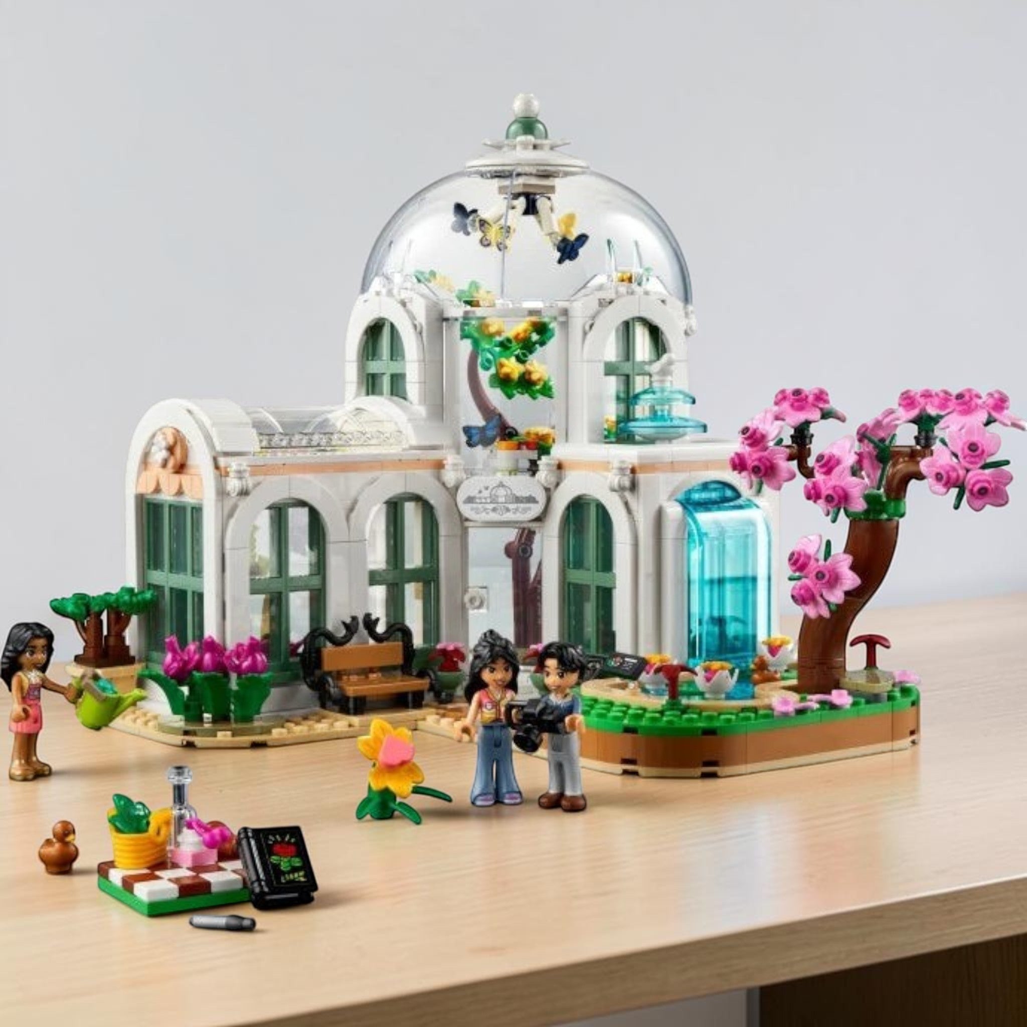 A Brick Apart LEGO Friends Botanical Garden set featuring a glass dome, exotic plants, and three mini-doll figures.