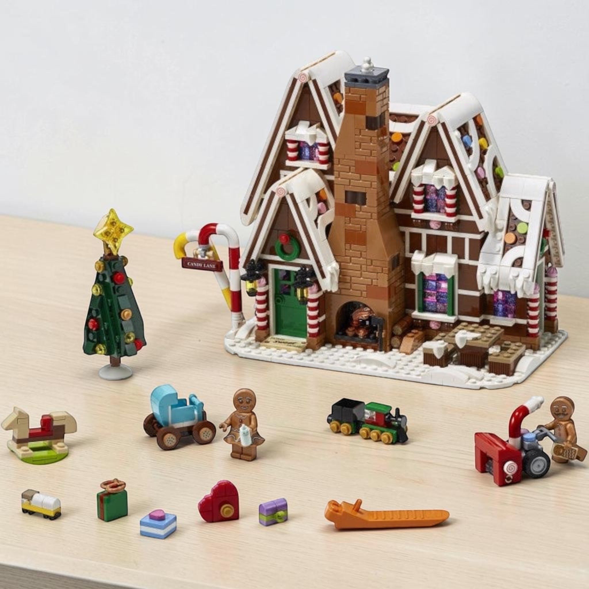 A Brick Apart LEGO Creator Expert Gingerbread House set with candy-themed details, Christmas tree, and minifigures.