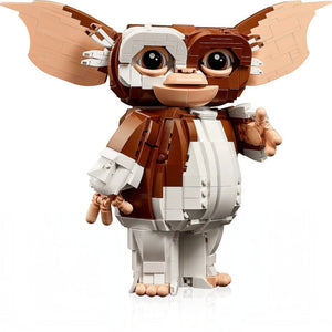 A Brick Apart LEGO Ideas Gizmo figure from Gremlins with posable ears, arms, and head on a white background.