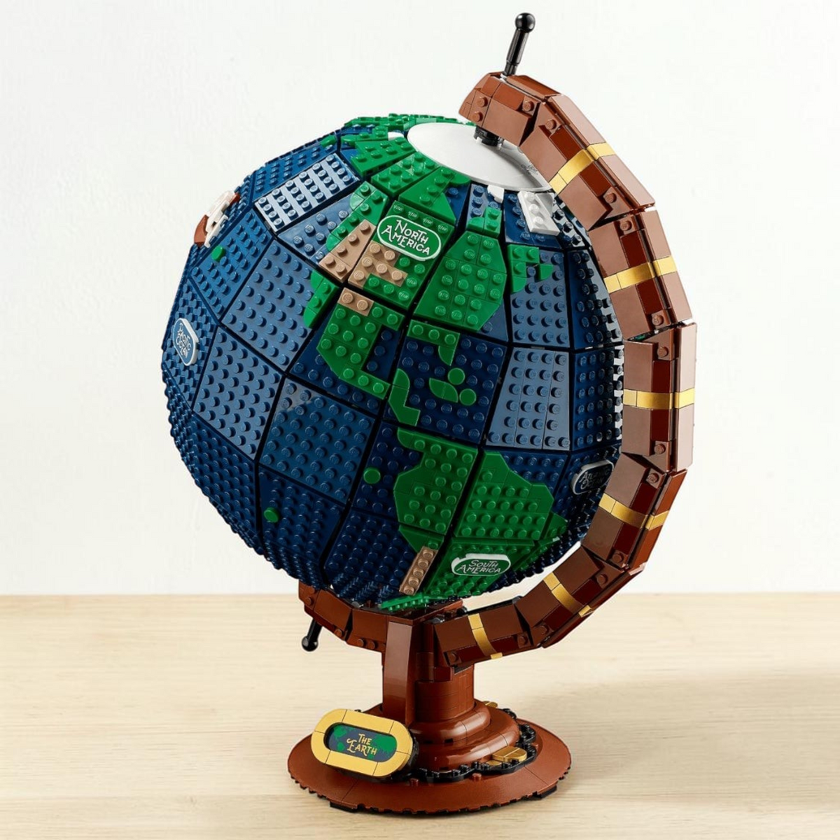 [lifestyle-shelf-built] A Brick Apart LEGO Ideas The Globe set featuring a spinning vintage Earth model with blue and green brick continents.