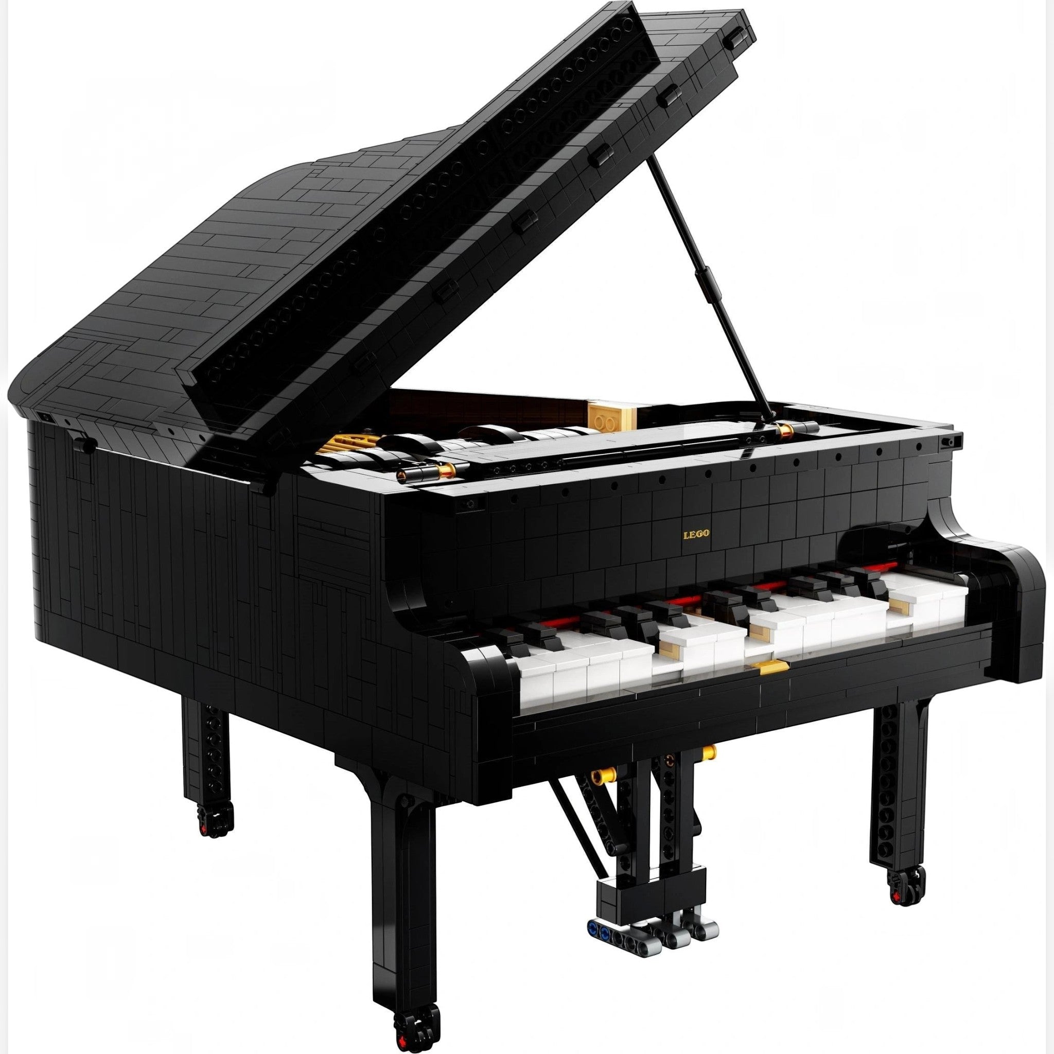 A Brick Apart LEGO Ideas Grand Piano model with black exterior, white keys, and an open lid showing internal details.