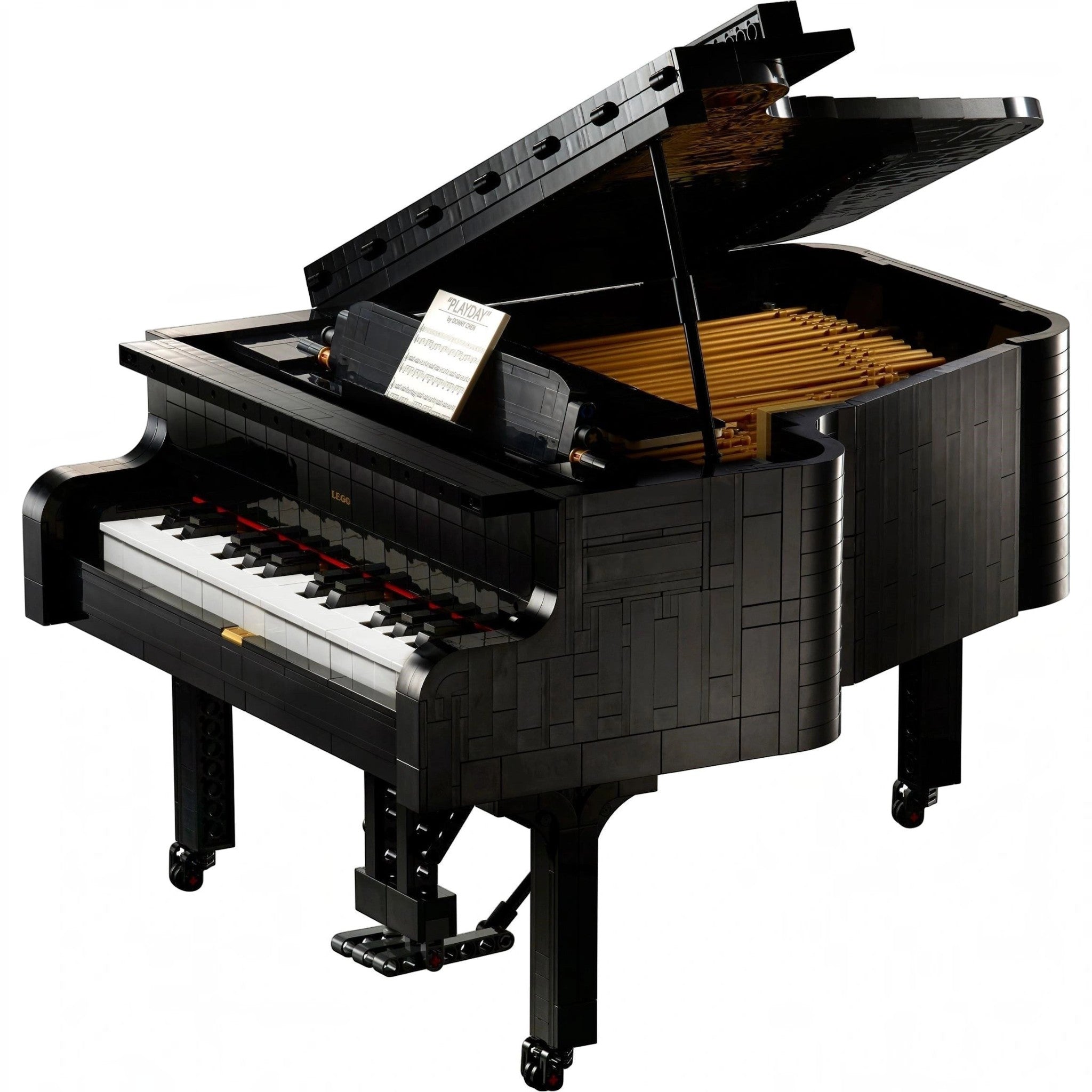 A Brick Apart LEGO Ideas Grand Piano model with black casing, white keys, and an open lid showing internal details.