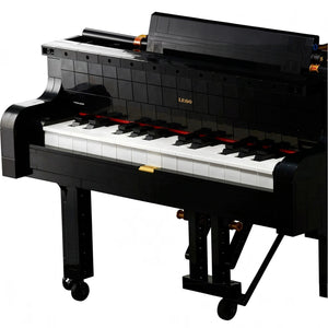A Brick Apart LEGO Ideas Grand Piano model with black casing, white keys, and authentic moving hammer action mechanism.