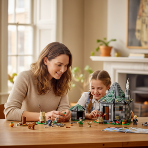 [lifestyle-person] A Brick Apart LEGO Harry Potter Hagrid's Hut set being built by a smiling mother and daughter at a wooden table.