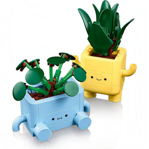 A Brick Apart LEGO Botanicals Happy Plants set featuring a baby dracaena and pilea in cute yellow and blue pots.