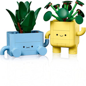A Brick Apart LEGO Botanicals Happy Plants set featuring a baby dracaena and pilea in cute blue and yellow pots.