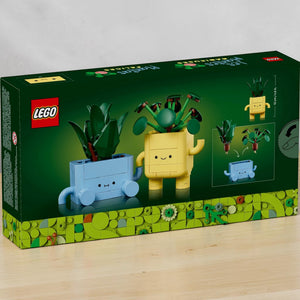 A Brick Apart LEGO Botanicals Happy Plants set box featuring a buildable baby dracaena and pilea in cute face pots.