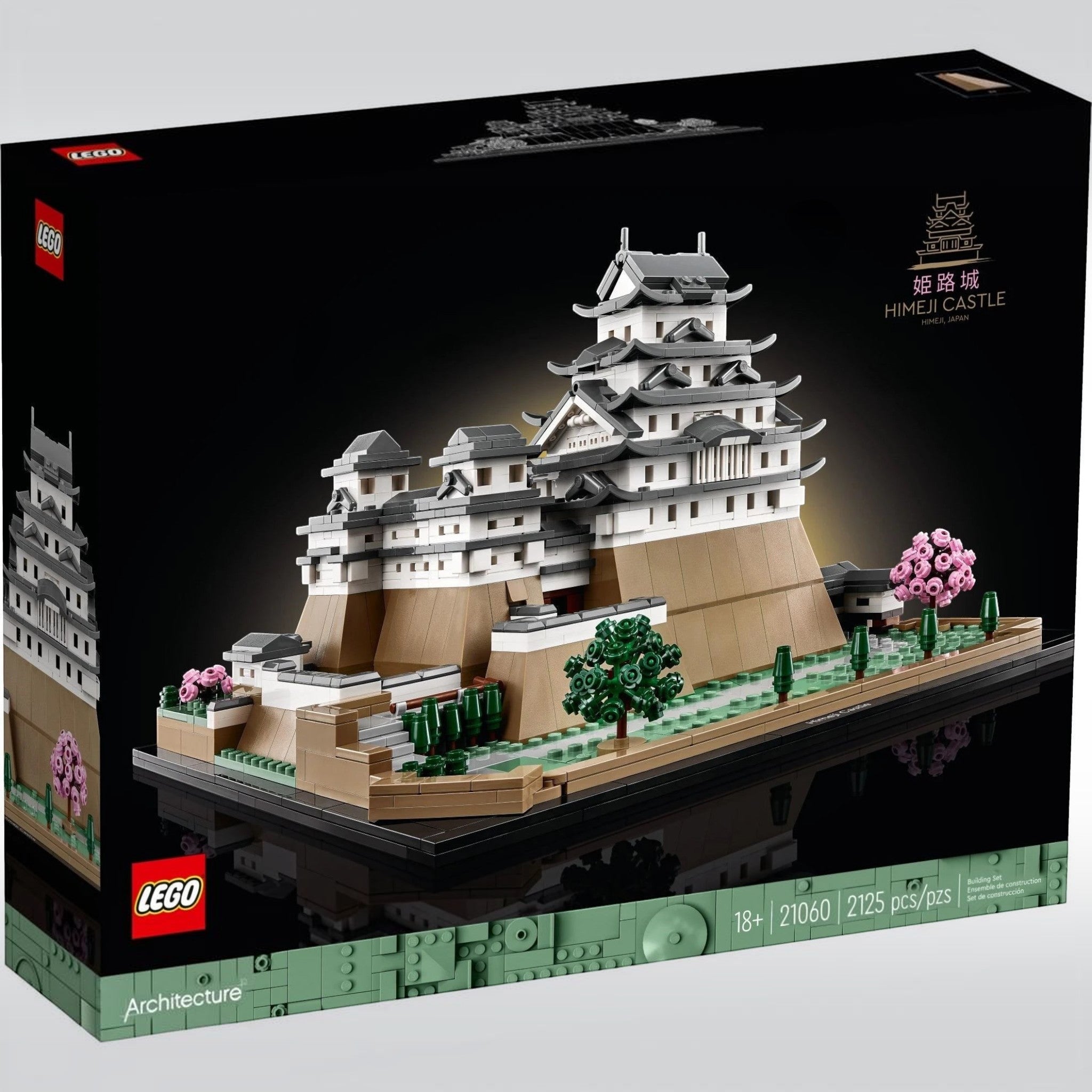 A Brick Apart LEGO Architecture Himeji Castle display model featuring white turrets, stone walls, and cherry trees.