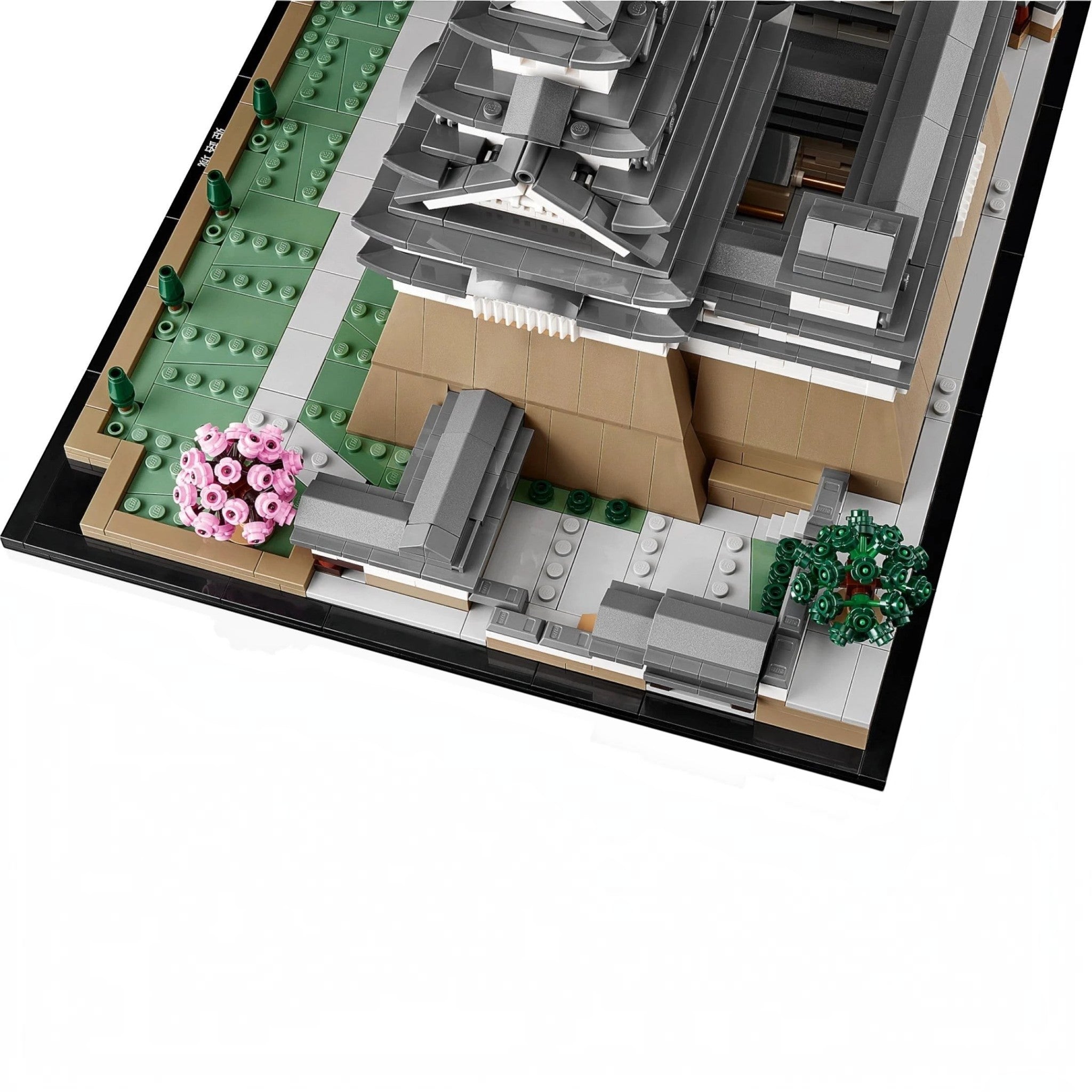 A Brick Apart LEGO Architecture Himeji Castle model featuring grey turrets, tan stone walls, and pink cherry trees.