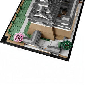 A Brick Apart LEGO Architecture Himeji Castle model featuring grey turrets, tan stone walls, and pink cherry trees.