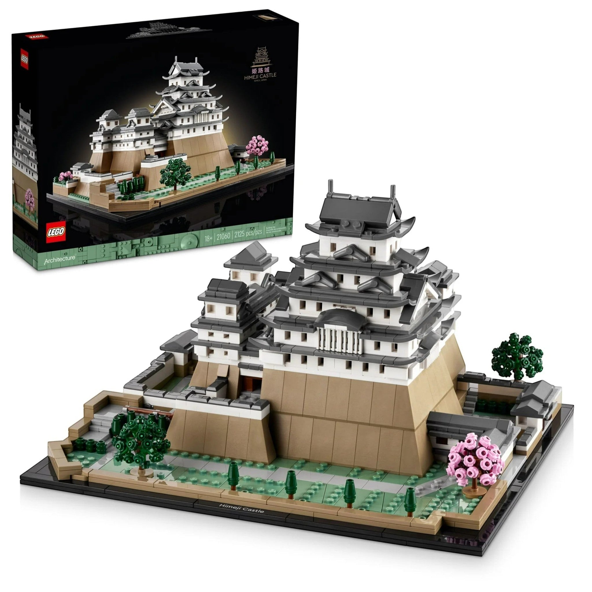 A Brick Apart LEGO Architecture Himeji Castle model with white turrets, tan walls, and pink cherry trees on display.