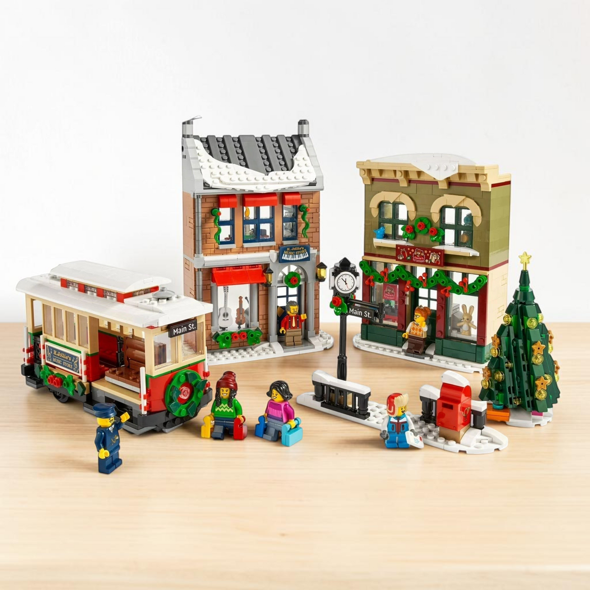[lifestyle-shelf-built] A Brick Apart LEGO Holiday Main Street set featuring a festive streetcar, toy store, music store, and Christmas tree.