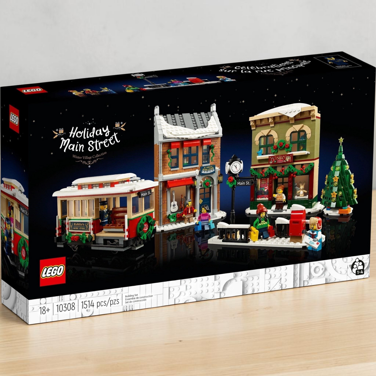 [lifestyle-shelf-box] A Brick Apart LEGO Icons Holiday Main Street set box featuring a festive streetcar, toy store, music shop, and tree.