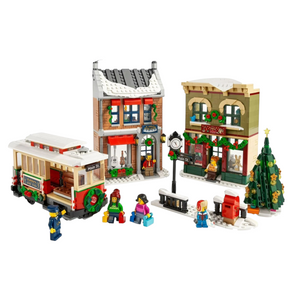 [built-white] A Brick Apart LEGO Holiday Main Street set featuring a festive streetcar, toy store, music store, and Christmas tree.