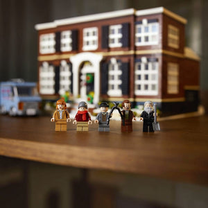 A Brick Apart LEGO Home Alone set featuring five minifigures standing in front of the detailed McCallister house model.