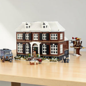 A Brick Apart LEGO Ideas Home Alone McCallisters house set with minifigures, tree house, and van on a white background.