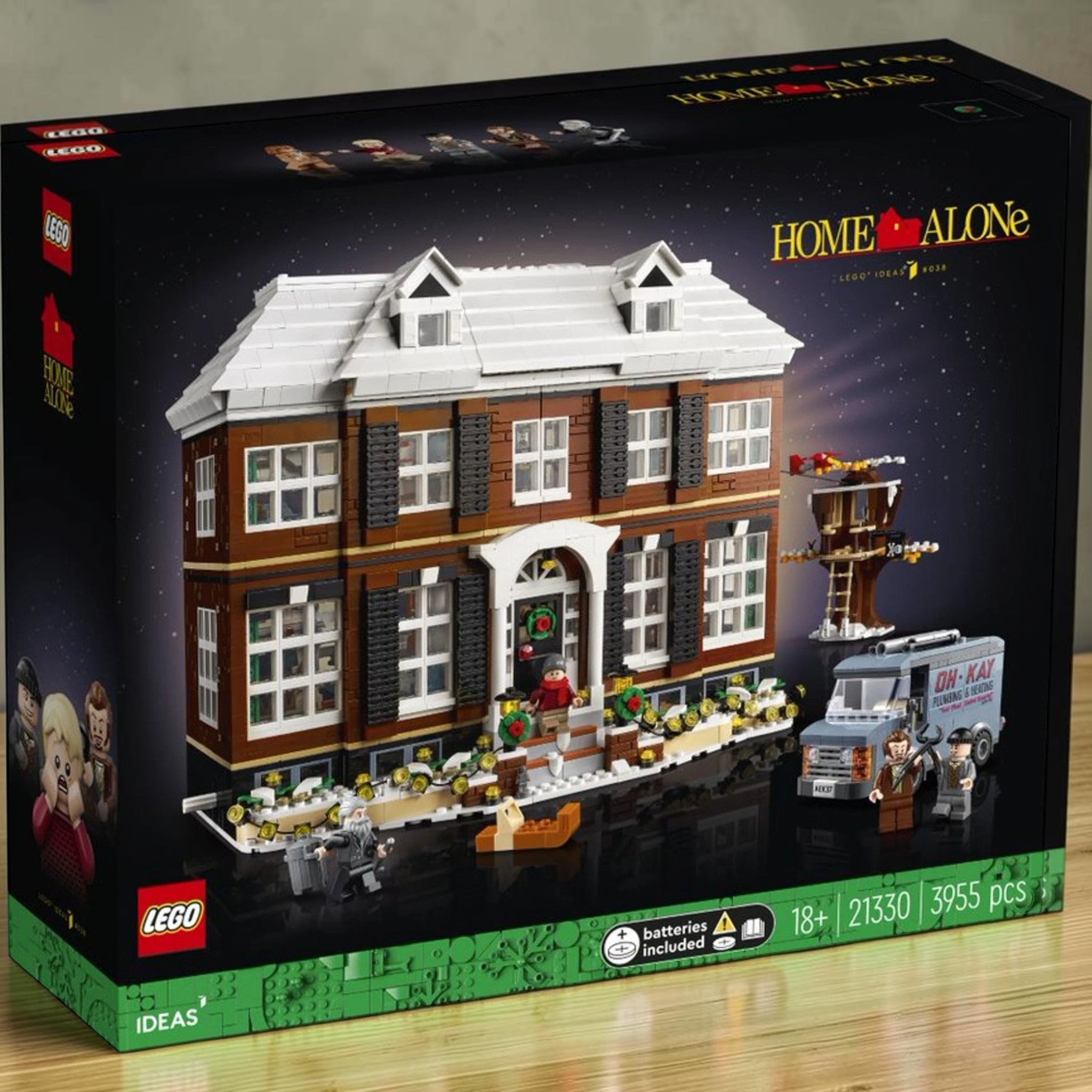 A Brick Apart LEGO Ideas Home Alone set featuring the McCallisters house, minifigures, and the Oh-Kay plumbing van.
