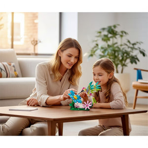 A Brick Apart LEGO Creator 3-in-1 Hummingbird set being built by a mother and daughter at a wooden table.