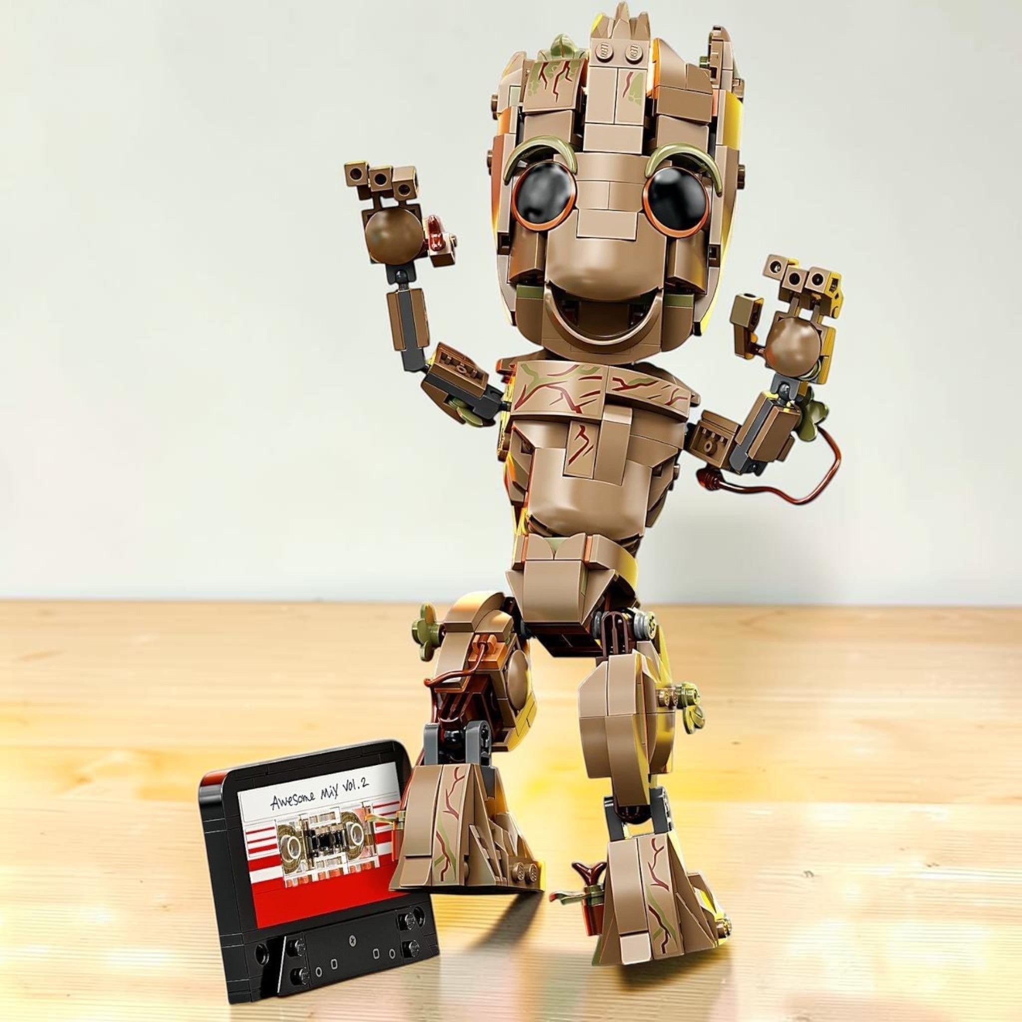 A Brick Apart LEGO Marvel I am Groot buildable figure posing with a pretend Awesome Mix Vol 2 cassette tape