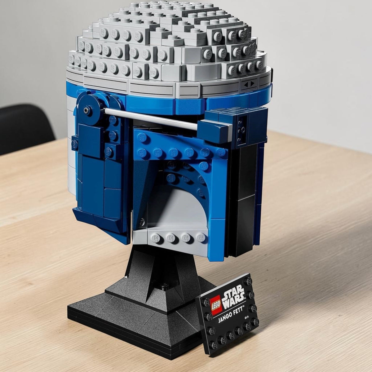 [lifestyle-shelf-built] A Brick Apart LEGO Star Wars Jango Fett helmet model with blue and grey bricks on a black display stand with nameplate