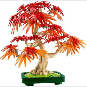 A Brick Apart LEGO Botanicals Japanese red maple bonsai tree with vibrant orange leaves in a dark green plant pot.