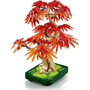 A Brick Apart LEGO Botanicals Japanese Maple Tree with vibrant red and orange leaves in a dark green bonsai pot.