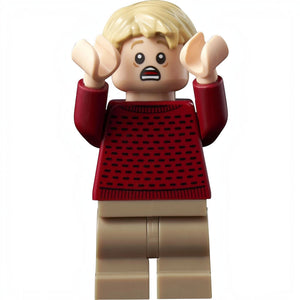A Brick Apart LEGO Kevin McCallister minifigure from Home Alone with a shocked expression in a red sweater and tan pants