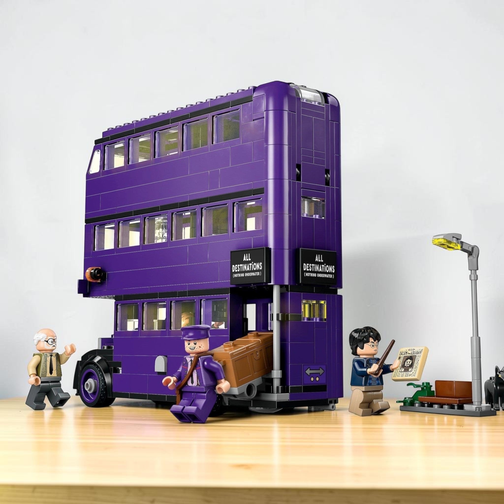 A Brick Apart LEGO Harry Potter Knight Bus set featuring the purple triple-decker bus, minifigures, and a lamppost.
