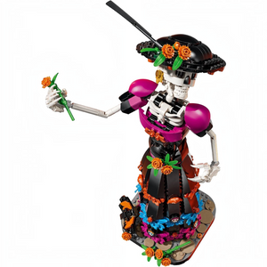 [built-angle] A Brick Apart LEGO Ideas La Catrina skeletal figurine wearing an ornate black and magenta dress with marigold flowers.