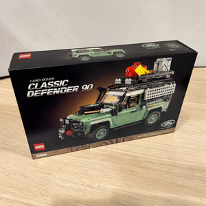 [lifestyle-shelf-box] A Brick Apart LEGO Icons Land Rover Classic Defender 90 set box featuring a sand green off-road vehicle model.