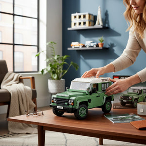 A Brick Apart LEGO Icons Land Rover Classic Defender 90 model in sand green being assembled on a wooden table.
