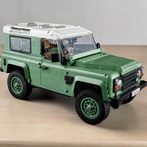 A Brick Apart LEGO Icons Land Rover Classic Defender 90 model in sand green with a white roof and authentic details.