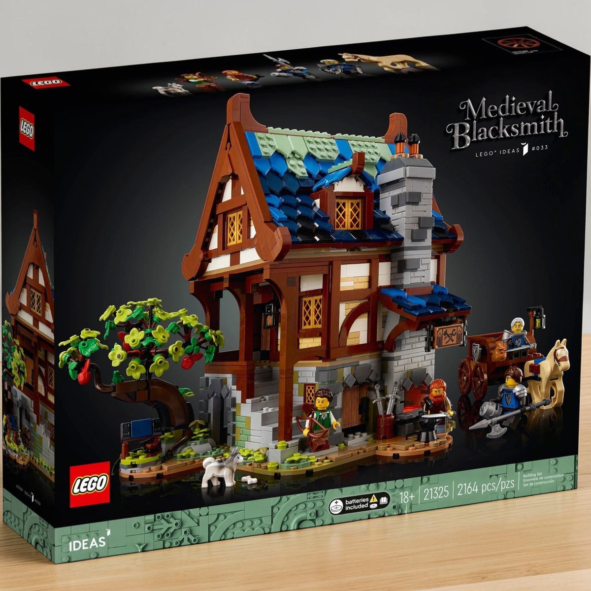 [lifestyle-shelf-box] A Brick Apart LEGO Ideas Medieval Blacksmith set box featuring a detailed timber-framed workshop with minifigures.