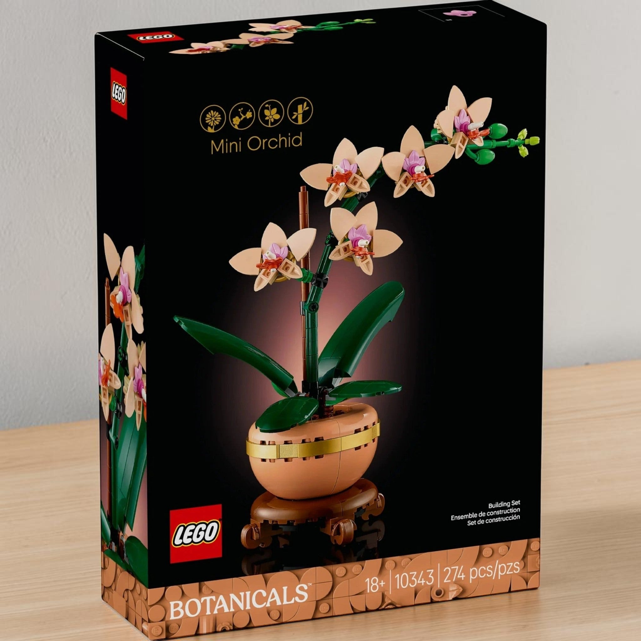 A Brick Apart LEGO Botanicals Mini Orchid building set box featuring a peach flower in a terracotta pot on a plinth.