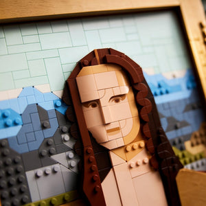 A Brick Apart LEGO Art Mona Lisa set featuring a brick-built portrait with blue landscape background and gold frame.