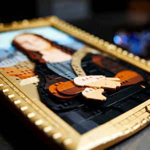 A Brick Apart LEGO Art Mona Lisa set featuring a brick-built portrait in a gold frame with blue and brown tones.