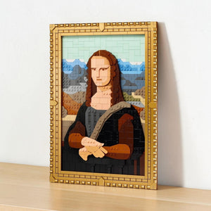 A Brick Apart LEGO Art Mona Lisa set featuring a brick-built painting in a gold frame with a matching product box.