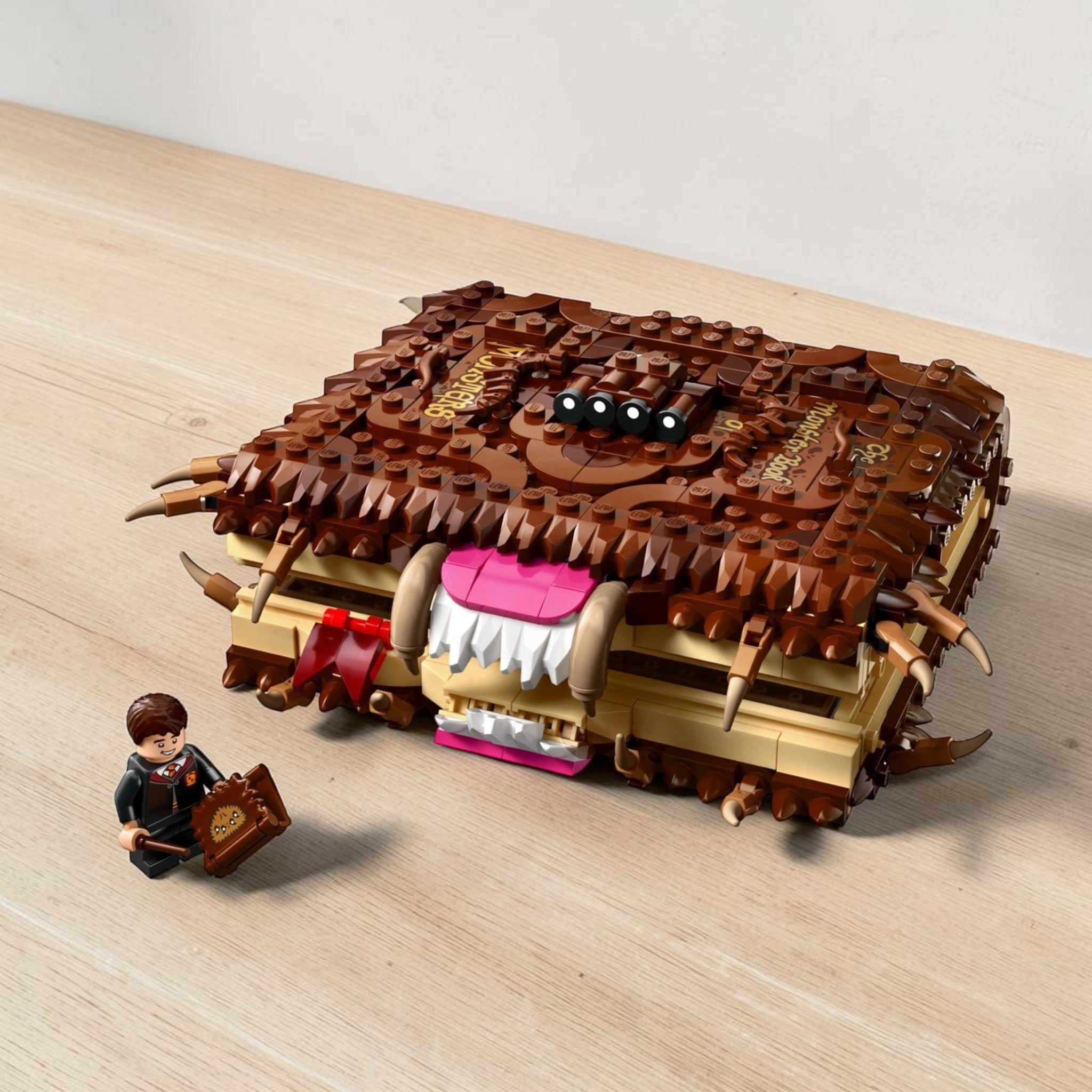 A Brick Apart LEGO Harry Potter Monster Book of Monsters set with a Neville Longbottom minifigure and display box.