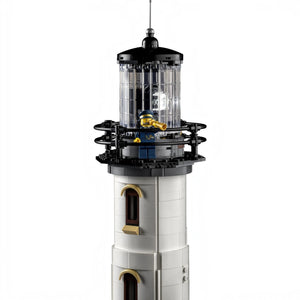 A Brick Apart LEGO Ideas Motorised Lighthouse tower with a rotating light, Fresnel lens, and a lighthouse keeper.