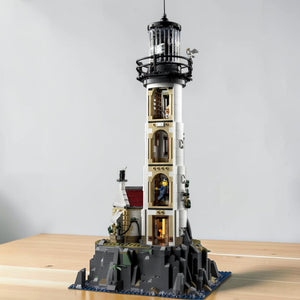 A Brick Apart LEGO Ideas Motorised Lighthouse set featuring a tall white tower with a rotating light on rocky base