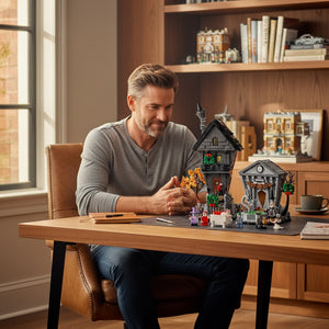 [lifestyle-person] A Brick Apart man building the LEGO Ideas Nightmare Before Christmas diorama set on a wooden desk in a home office.