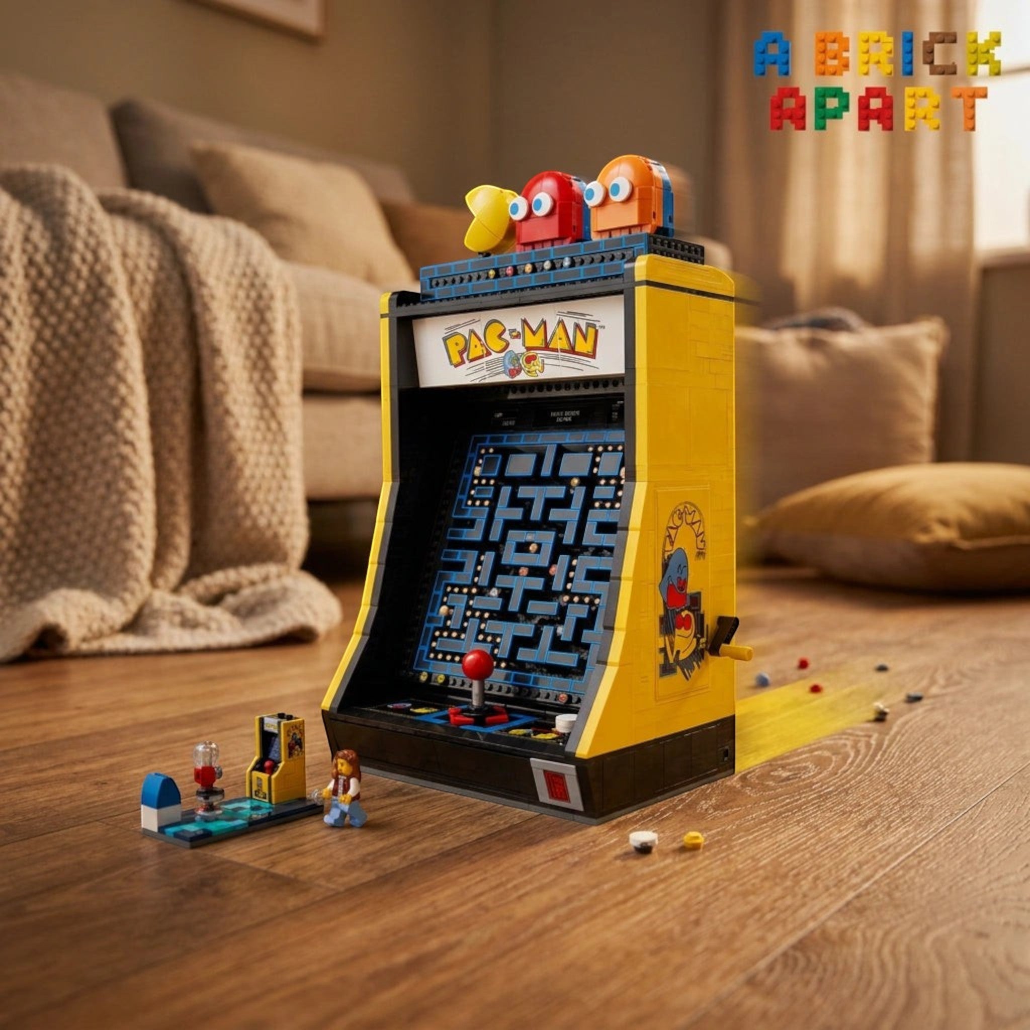 A Brick Apart LEGO Icons PAC-MAN arcade cabinet model with a functional joystick and rotatable character figures.