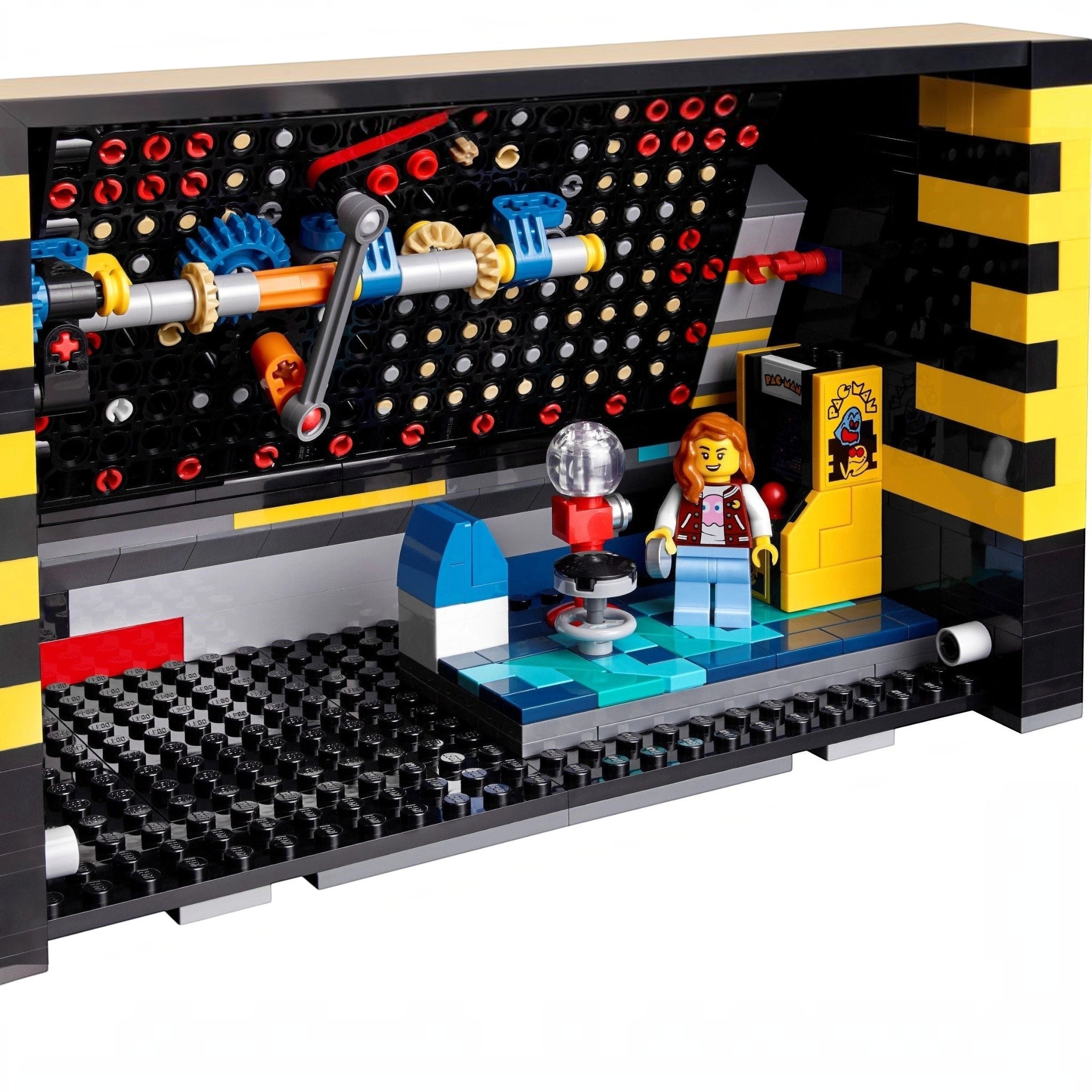 A Brick Apart LEGO Icons PAC-MAN Arcade interior showing a minifigure in a retro 1980s arcade scene with mechanical gears.