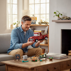 A Brick Apart man building the red LEGO Icons 1950s pickup truck model with seasonal accessories on a living room table
