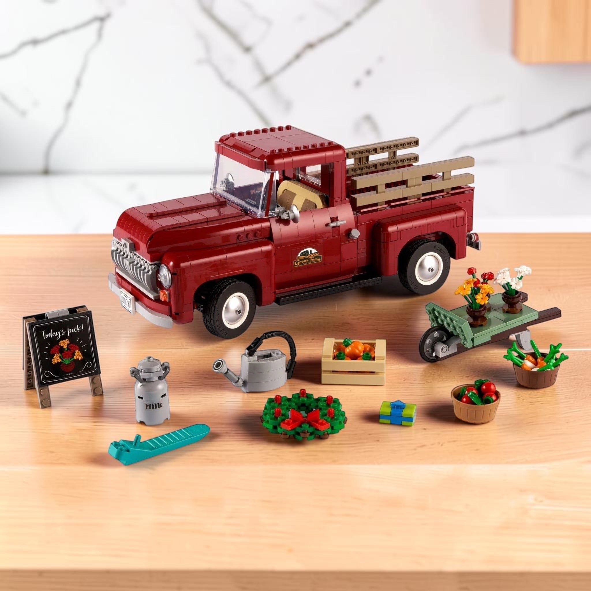 A Brick Apart LEGO 10290 Icons Pickup Truck in dark red with seasonal accessories like flowers and a wheelbarrow.