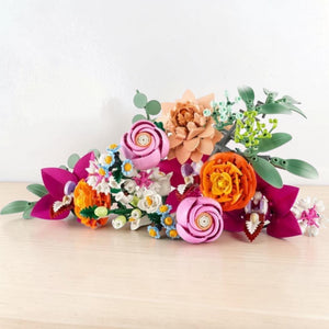 A Brick Apart LEGO Botanicals Pretty Pink Flower Bouquet featuring assorted colorful plastic flowers and green stems.