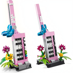 A Brick Apart LEGO Creator 3in1 pink keytar musical instrument model with colorful brick-built flowers on a stand.