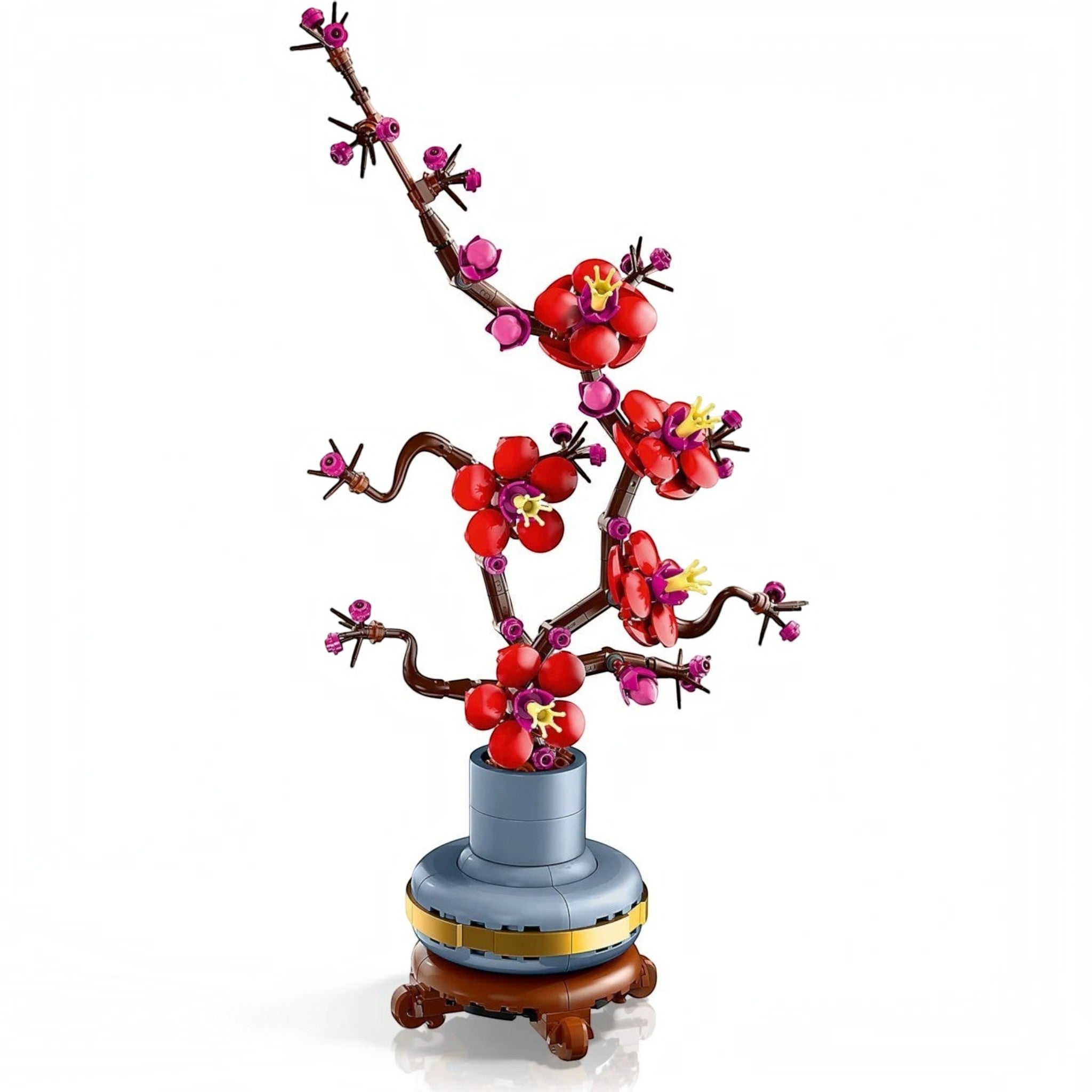 A Brick Apart LEGO Icons Plum Blossom set featuring red and magenta flowers on a woody stem in a pastel-blue pot.