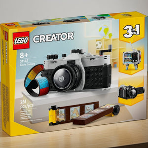 [lifestyle-shelf-box] A Brick Apart LEGO Creator 3in1 Retro Camera building set box featuring a brick-built camera with a colorful film strip