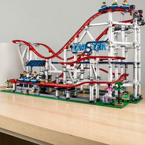 A Brick Apart LEGO Creator Expert Roller Coaster set featuring red tracks, white support beams, and 11 minifigures.